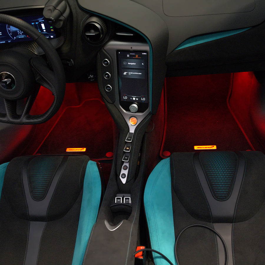 Red footwell lighting in the blue McLaren, showing the driver and passenger footwells